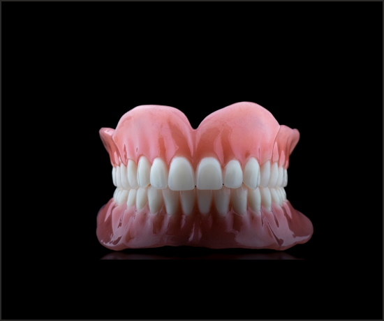 Acrylic denture set on a clean white background